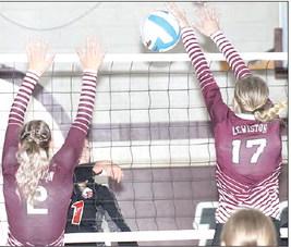 Paula Jasa/Republican P.C.’s Logan Maloley (#11, left) splits the LHS defense of Madeline Janssen (#2) and Meagan Sanders (#17).