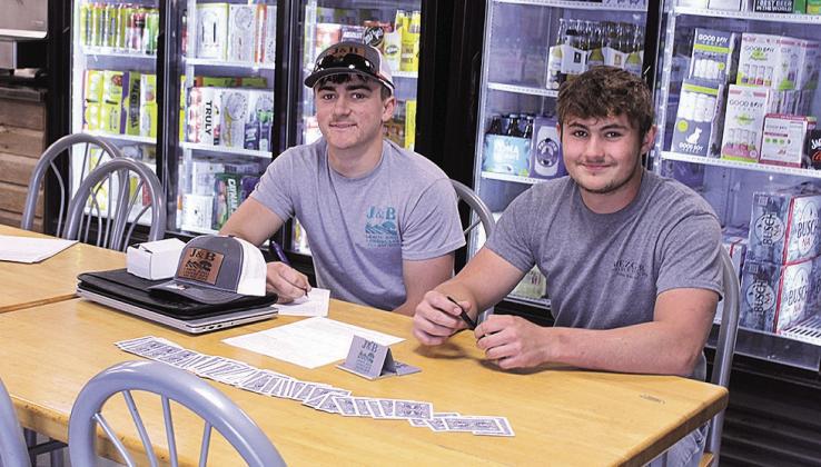 Jaydon Johnson (left) and Wyatt Blank (right) of J&amp;amp;B Lawn and Landscape were two of the business owners set up in The Little Brown Jug