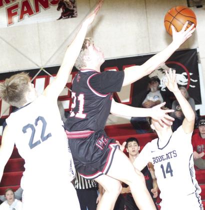 P.C.’s Trey Marteney drives to the hoop inbetween several E-M-F Bobcat defenders in Saturday’s 3rd place game at the Pioneer Conference Tournament. Paula Jasa/Republican