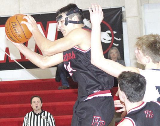 P.C.’s Atreyu Kling (#24, center) pulls in a tough rebound against E-M-F on Saturday. Paula Jasa/Republican