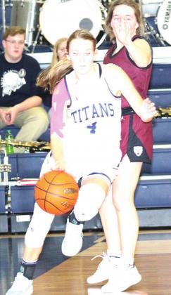 Paula Jasa/Republican HTRS’ Gracie Shafer (#4) drives the baseline against LHS’ Carleigh Weyers in Tuesday night’s game.