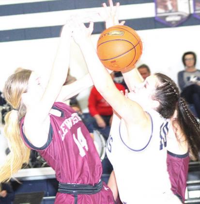 Paula Jasa/Republican LHS’ Meagan Sanders (#14, left) battles HTRS’ Jacey Leech (#10, right) for a tough rebound.