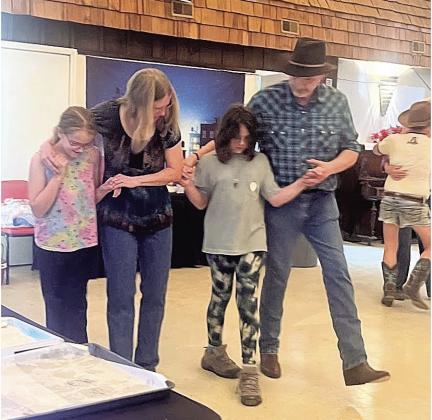 Learning the dance – Savannah Weimers and Lulu Evans of Table Rock taken under the wing of experienced dancers