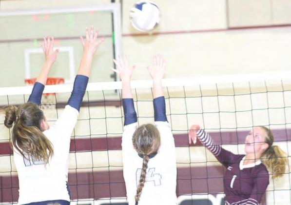 LHS’ Becca deKoning (#1, right) attacks against HTRS’ Jacey Leech (#10, left) and Ashton Bredemeier (#14, center) in Tuesday night’s game. Paula Jasa/Republican
