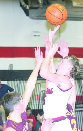 P.C.’s Justin Pierce (#5, center) puts up a shot over several Sterling defenders in Friday night’s game. Paula Jasa/Republican