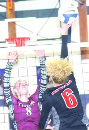 P.C.’s Madelyn Osborne (#6, right) goes up for a tip over LHS’ Maddie Janssen (#8, left) at the Pioneer. Paula Jasa/Republican
