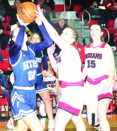HTRS’ Lillian Bowen (left) tries a baseline shot against Pawnee City’s Cameron Ottersberg as teammate Hallye Friedly (#15, right) looks on. Paula Jasa/Republican