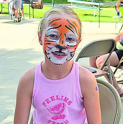 Madison Lewis enjoys the face paint provided by Taylor Porter