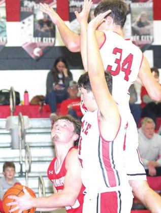 P.C.’s Bryce Gyhra (#34 right) and Joseph Marteney (center) go up to block a shot against a Frankfort player. Paula Jasa/Republican