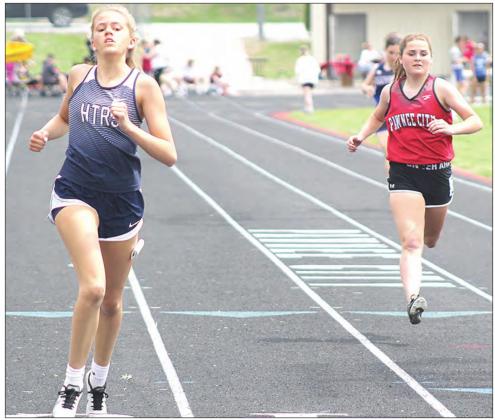 Paula Jasa/Republican HTRS’ Avery Dierberger (left) and Pawnee City’s Emma Meints (right) finish strong in the girls’ 200 M. Dash event. Dierberger finished 5th with a time of 30.16.