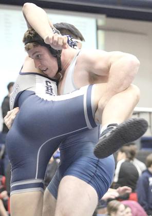 HTRS/P.C.’s Andy Maloley (above, right) picks up his opponent and gets ready to put him down while teammate Ty Faulks (left) goes for a pin on Saturday. photos provided by Jamie Maloley