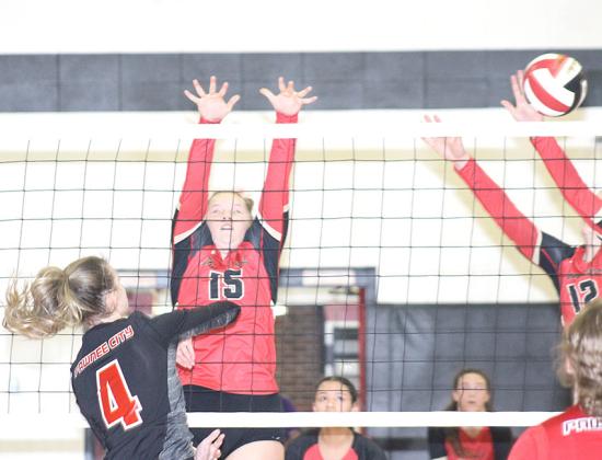 P.C.’s Mallory Branek (#4, left) drills one of her 7 kills past two JCC defenders in Thursday night’s game. P.C. lost in three sets, 15-25, 19-25, 11-25. Paula Jasa/Republican