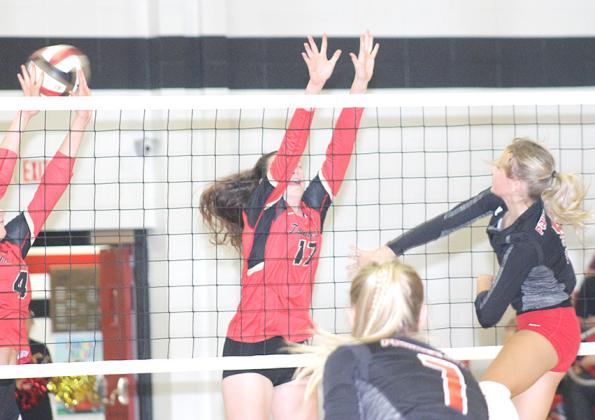 P.C.’s Madison Fender (right) records a kill against JCC’s Ashley Beethe (#17) and Sunnie Rother (#4, left). Fender had 7 kills in the contest. Paula Jasa/Republican