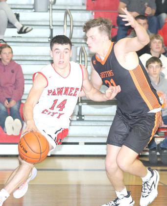 P.C.’s Jett Farwell (#14, left) drives the baseline past a Griffin defender. Farwell scored 18 points and had 10 rebounds for a double double against D/O. Paula Jasa/Republican