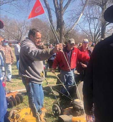 Volunteer Fire Fighter Rick Hunzeker marks an item as the auctioneer works his magic
