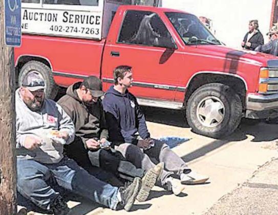 Volunteer fire fighters take a brief and much needed break. Items were taken all day Friday, and on Saturday the fire fighters stepped up to mark items, take bids, move the auctioneers trucks forward along the long line of sale items, and otherwise keep busy. Pictured are Travis Findlay, Bill Vogt and Joey Tyler. Sharla Sitzman Photos