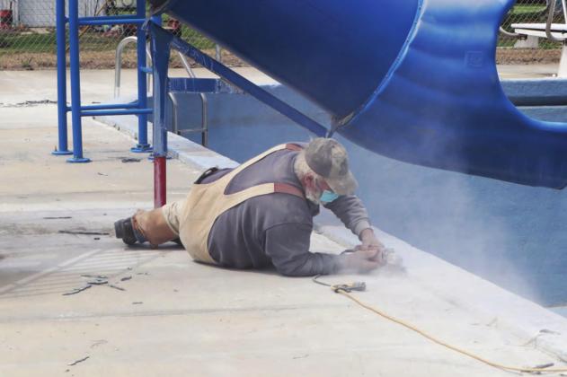 Steve Kreifels works at grinding off the cold joints at the pool. Ray Kappel/Republican