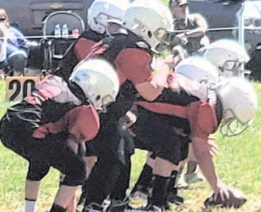 VICTORY FORMATION - The Pawnee City Peewee Football team prepares to take a knee in their game.