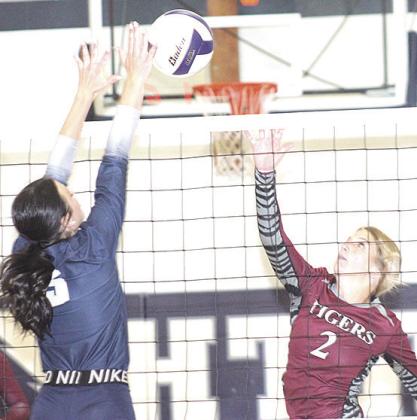 HTRS’ Lillian Bowen (#5, left) gets her hand on a block against LHS’ Justice Currie (#2, right). Paula Jasa/Republican