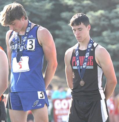 P.C.’s Jett Farwell (right) on the podium for 3rd in the 400 M. Dash. (photo courtesy of Stephanie Croston)