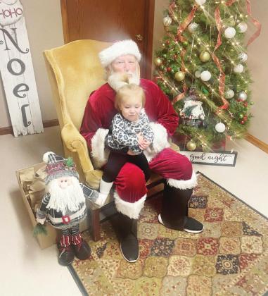 Ray Kappel/Republican Lydia Burgett gets to visit with Santa at the Chamber Festival Thursday.