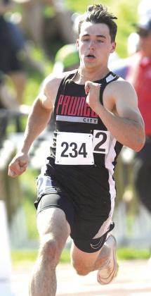 P.C.’s Jett Farwell rounds the corner of the Class D boys’ 400 M. Dash. He placed 6th with a time of 51.95. Photo by Luke Nichols/Beatrice Daily Sun