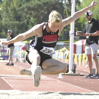 P.C.’s Trey Marteney goes in for a landing in the Class D boys’ Triple Jump event on Friday. Photo by Luke Nichols/Beatrice Daily Sun