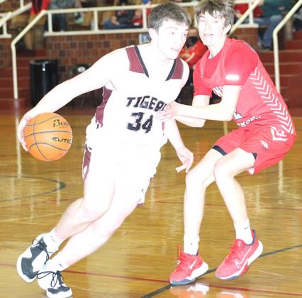Lewiston’s Hayden Christen drives the lane against Johnson-Brock on Saturday. Christen led the Tigers with 15 points in the game. Paula Jasa/Republican