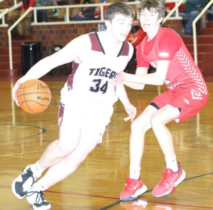Lewiston’s Hayden Christen drives the lane against Johnson-Brock on Saturday. Christen led the Tigers with 15 points in the game. Paula Jasa/Republican