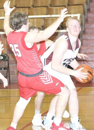 LHS’ Jonathan Janssen (right) drives the baseline and draws a foul against Johnson-Brock. Paula Jasa/Republican