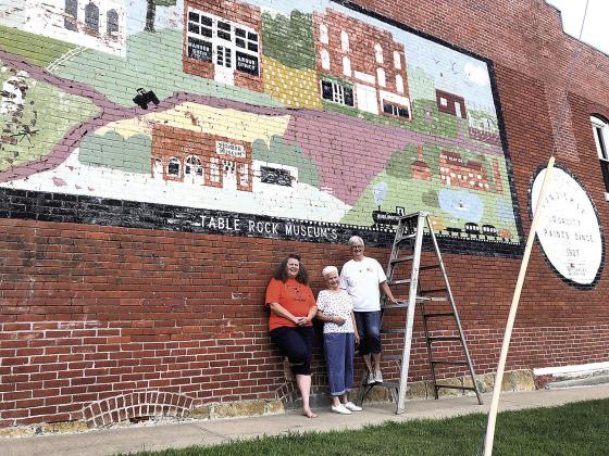 Above: In 2020, Suzanne Ellis, Elsie Tomek, &amp;amp; Barb Sandusky. They helped paint the mural in 1979.