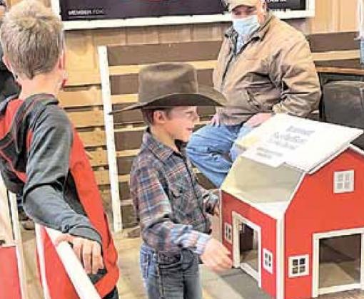 Weston Niss (back to camera) and Reid Niss with the barn that was donated for the auction.