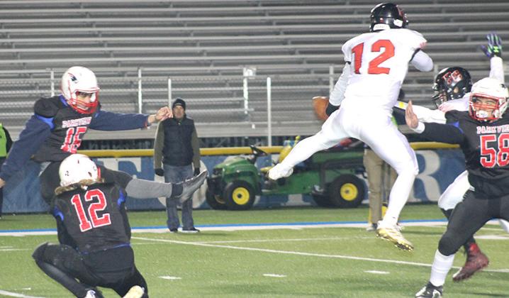Pawnee City’s Andy Maloley (#12, center) blocks a PAT kick late in the game against Parkview Christian. Paula Jasa/Republican