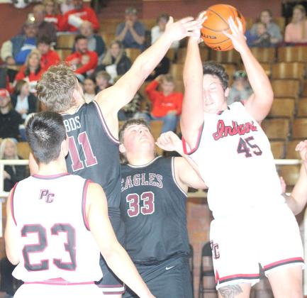 P.C.’s Joey Marteney (#45, right) pulls down a tough defensive rebound as teammate Anthony Kling (#23, left) looks on in the Class B Boys’ Mudecas Championship game. Pawnee City defeated BDS 54-50 on Saturday to claim the 1st place trophy. Paula Jasa/Republican