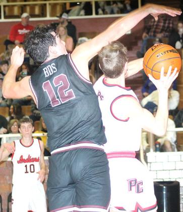 P.C.’s Justin Pierce (#5, right) drives the baseline and draws a foul underneath the basket as teammate Drew Menninga (#10, left) looks on. Paula Jasa/Republican