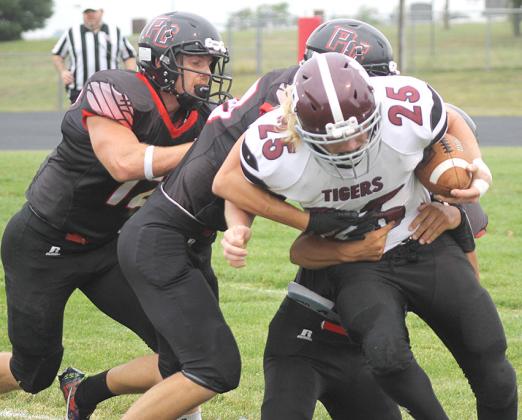 LHS’ Tristen Ray (#25, right) tries to power past several P.C. tacklers including Andy Maloley (#12, pictured left). Ray had 30 carries for 140 yards to lead LHS. Paula Jasa/Republican