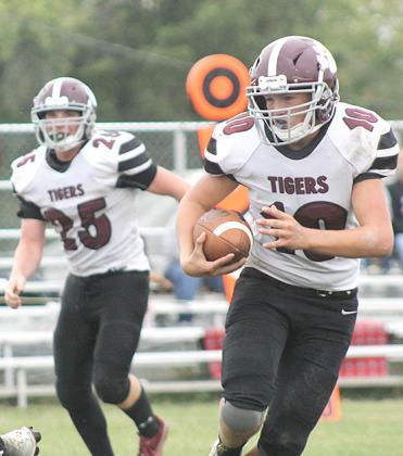 Lewiston’s Everett Bohling (#10, right) takes off over the left side to score a late touchdown for the Tigers in the 4th quarter. Bohling had 18 carries for 49 yards and 2 touchdowns against Pawnee City. Also pictured is teammate Tristen Ray (#25). Paula Jasa/Republican
