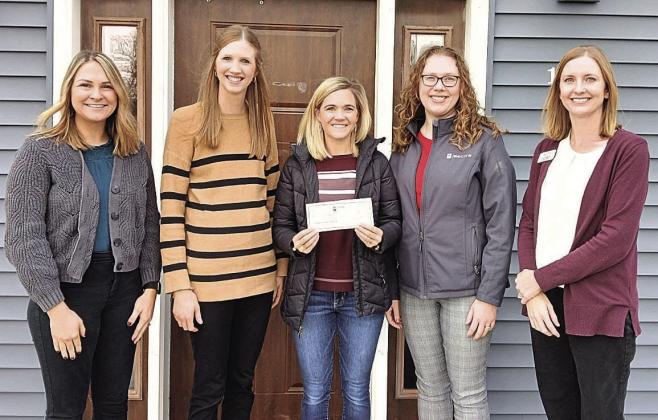 Employees of Sweet Second Home Child Care Center accept a check from State Bank of Table Rock and Community Insurance Group. From left to right: Shelby Barnes, Janae Frase, Amanda Niss, Lisa Laun, Kristen Herrick