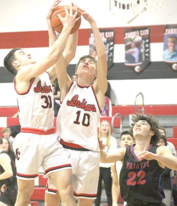 P.C.’s Jett Farwell (#30 left) and Drew Menninga (#10, right) battle for a rebound against Palmyra last Thursday night. Paula Jasa/Republican