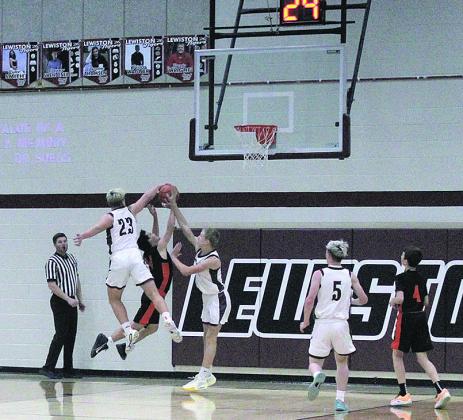 Lewiston Sophomore Brock Janssen leaps to block a score by a Dorchester Longhorn