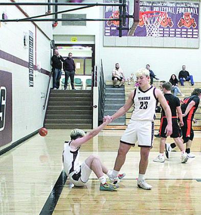 Lewiston Sophomore Brock Janssen helps his teammate to his feet