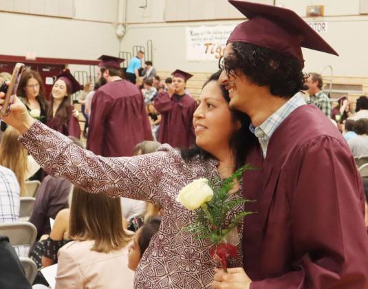 Lewiston Senior Abel Gonzalez shares a moment with his mom, Santa, at the Lewiston Graduation Sunday. Ray Kappel/Republican