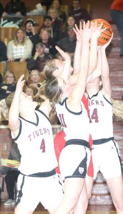 LHS’ Emma deKoning (#4, left) Carleigh Weyers (#11, center) and (Meagan Sanders (#14, right) battle a Meridian player for a rebound early in the Class B Girls’ Mudecas Championship game. LHS had a tough start and lost the game by a 25-41 score. Paula Jasa/Republican