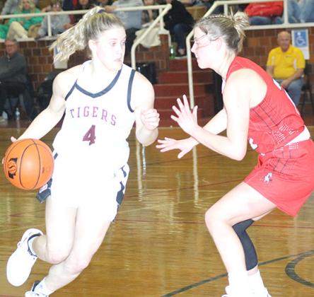 LHS’ Emma deKoning (#4, left) drives the lane against a Meridian player in Friday night’s Championship game. Paula Jasa/Republican