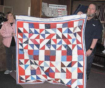 Holding Quilt: Verna Kalina who made the quilt and Jeffery Day. Photos by Betty Davis, Republican