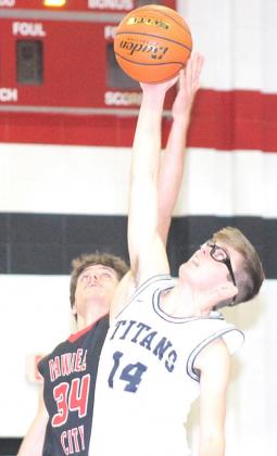 P.C.’s Bryce Gyhra (#34, left) and HTRS’ Gage Schaardt (#14, right) tip it off in the Pioneer Conference game which matched the Indians and the Titans. Paula Jasa/Republican