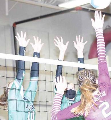 LHS’ Masyn Arena (#2, right) elevates for a spike over two FCSH defenders on Thursday night. Paula Jasa/Republican
