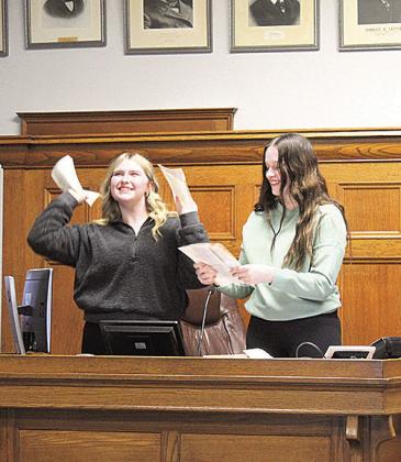 Adilyn Nincehelser (left) and Lexus Tichy (right) tear up Judge Gaertig’s books in their dramatization of “criminal mischief”