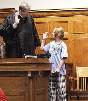 Pawnee City fifth grader Chloe is sworn in as a witness by Judge Gaertig