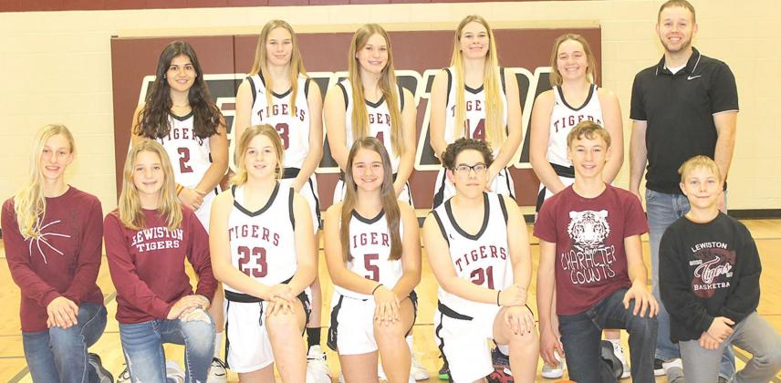 Members of the 2021-22 Lewiston Girls’ Basketball Team are front, from left: Maddie Janssen, s.m., Justice Currie, s.m., DeLanye Currie, Leah Christen, Delia Quintana, Payton Heideman, s.m., Evan Christen, s.m. Back row: Nayla Alos, Katelyn Sanders, Emma deKoning, Meagan Sanders, Carleigh Weyers, Head Coach Kyle Asche. Not pictured: Asst. Coach Alex Callan.